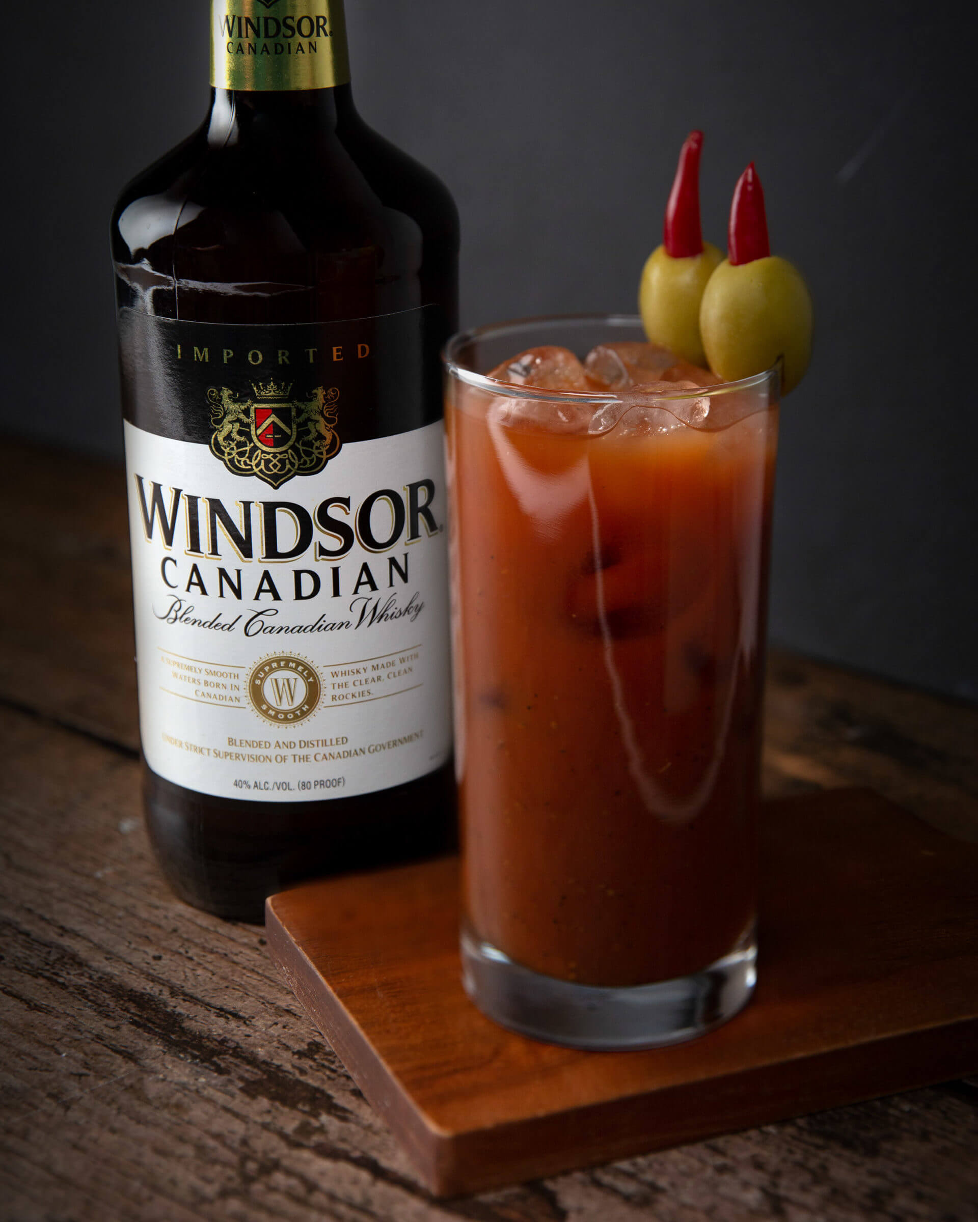 Windsor Canadian Blended Canadian Whisky 1L Bottle and Drink in Highball glass garnished with two olives with peppers.
